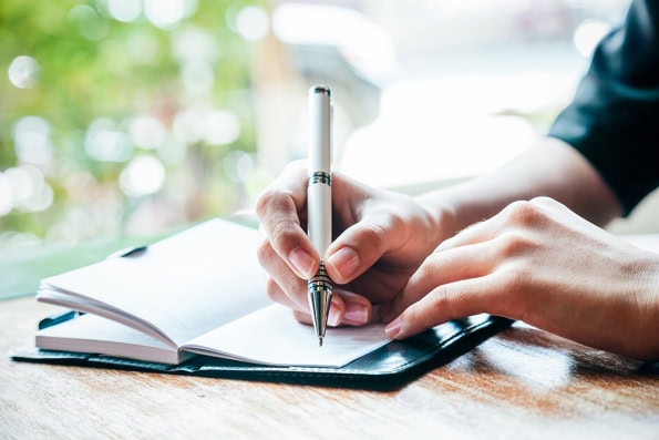 Woman writing in journal