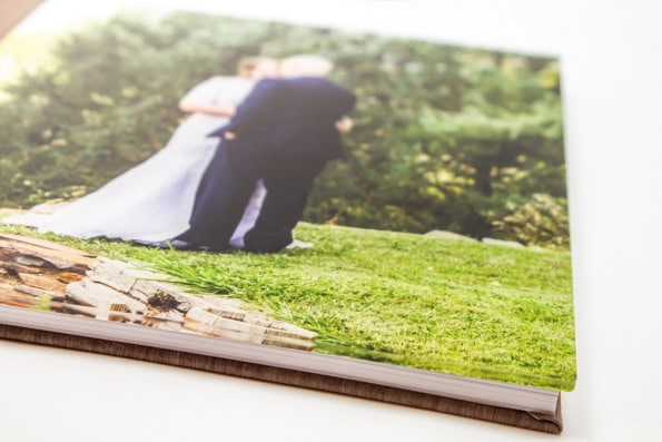 Photo book cover featuring an image of a bride and groom under a layer of clear acrylic